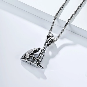 Detail of vintage Viking axe pendant with Valknut symbol on a steel box chain