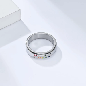 Polished stainless steel spinner ring featuring colorful rainbow PRIDE lettering