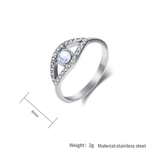 Macro detail of 8mm stainless steel evil eye ring with moonstone and white crystals