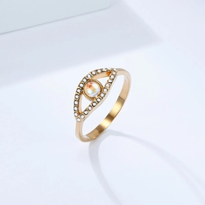 Macro detail of gold-plated evil eye ring with pavé crystals and iridescent gemstone