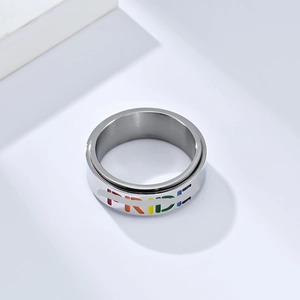 Detail view of silver spinner ring with rainbow colored PRIDE engraving for anxiety relief