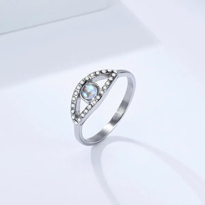 Detail view of silver steel ring with opal eye design and pavé crystal border