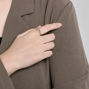 Elegant gold eye ring with opal gemstone and diamonds worn by model in business attire