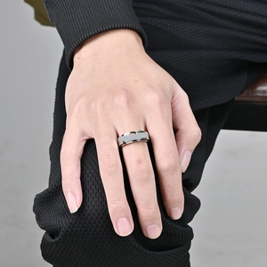 Mens minimalist silver stainless steel spinner ring shown worn on finger for anxiety relief