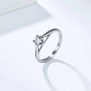 Macro detail of silver titanium steel ring featuring a four-prong set cubic zirconia stone