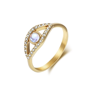 Brushed gold evil eye ring featuring moonstone center and pavé diamonds on white background