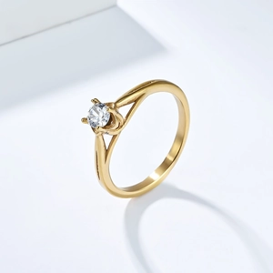 Detailed side view of golden stainless steel ring with four-prong set round cubic zirconia