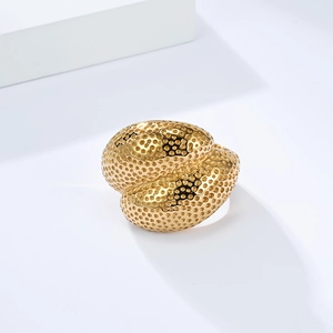 Detail of 18K gold-plated titanium ring featuring a honeycomb texture and twisted design