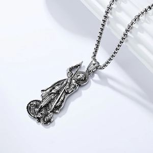 Macro detail of silver Saint George slaying the dragon relief on vintage steel pendant