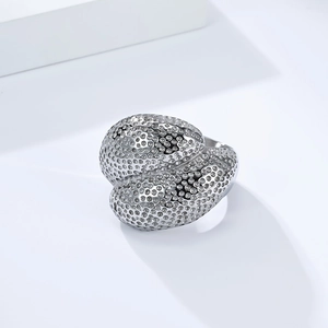 Macro shot of 18K gold plated steel ring featuring textured spheres and a modern shape