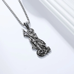 Macro detail of vintage Saint George and the dragon pendant in aged stainless steel