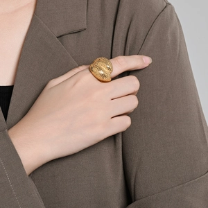Luxurious 18K gold-plated textured chunky ring on model's hand with vintage aesthetic