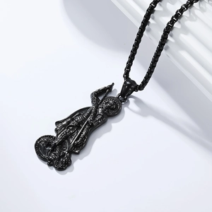 Detail of St. George and Dragon relief on a matte black vintage stainless steel pendant
