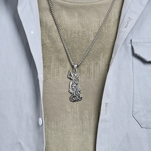 Vintage silver St. George Slaying the Dragon pendant on a stainless steel box chain