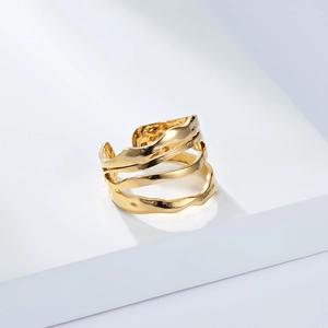 Detail of 18K gold plated titanium ring with irregular layered wave texture and lava style