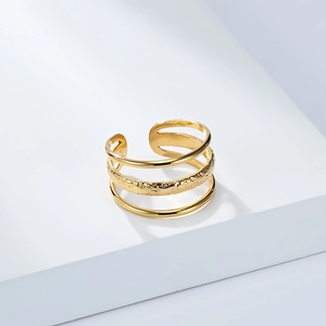 Detail of 18K gold-plated titanium steel ring with unique hammered texture and multi-layer design