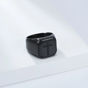 Detailed close-up of a matte black octagonal signet ring with a cross emblem for men