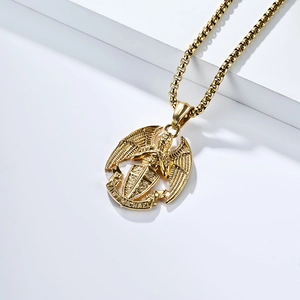 Macro detail of golden Saint Michael archangel pendant on a thick round box chain necklace