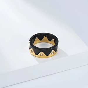Detail of crown ring showing black enamel and gold finish with micro-inlaid cubic zirconia