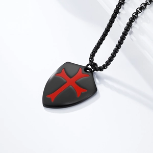 Close-up of matte black shield pendant with red cross on a black beaded chain