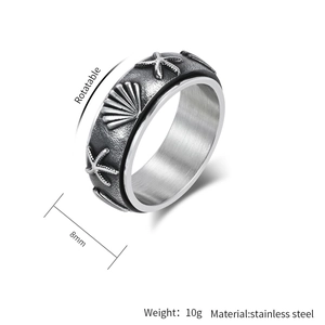 Detalle de anillo giratorio de 8mm en acero inoxidable con relieve de estrella de mar y concha