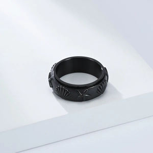 Detalle de anillo giratorio de acero negro con relieves de estrella de mar y caracolas