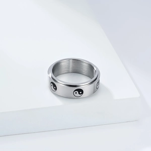 Detailed macro view of rotatable stainless steel ring with Yin Yang Tai Chi pattern