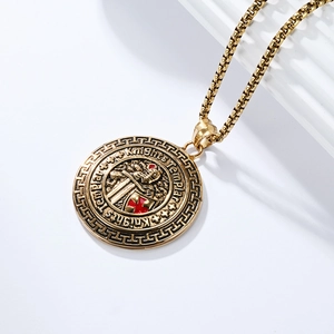 Macro view of gold Knights Templar shield pendant with red cross and box chain link detail