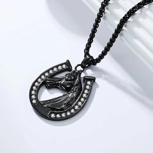 Detail of black horseshoe pendant with horse head relief and sparkling white zircon stones