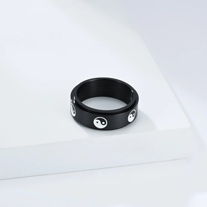 Black rotating stainless steel ring with white Yin Yang pattern symbols on matte finish