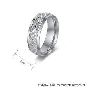 Macro view of 8mm stainless steel ring with rhombus pattern and polished edges