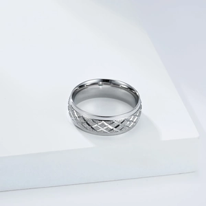 Detailed close-up of wide silver stainless steel ring with textured diamond lattice patterns