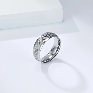 Macro shot of silver diamond-cut matte stainless steel ring showing modern geometric textures