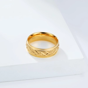 Detailed view of the gold diamond grid pattern and matte texture on the stainless steel ring