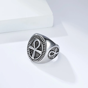 Macro detail of vintage silver Ankh cross ring showing the engraved shield surface