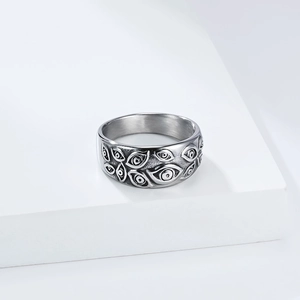 Makroaufnahme eines Punk-Edelstahlrings mit gravierten Teufelsaugen-Mustern im Detail