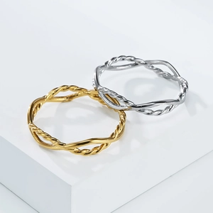 Detail view of woven geometric stainless steel rings in gold and silver finish