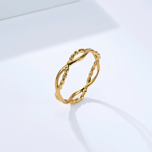 Macro detail of golden braided twist titanium steel ring with polished finish and glossy texture