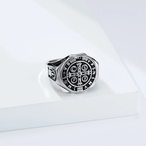 Macro detail of vintage stainless steel St. Benedict medal ring with religious carvings