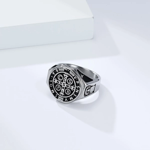Macro view of vintage Saint Benedict Medal ring featuring engraved cross and religious symbols