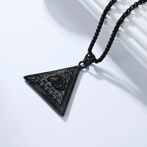 Macro detail of black Eye of Horus pyramid pendant on stainless steel bead chain