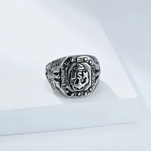 Detail view of vintage USN stainless steel ring with eagle and anchor relief carving