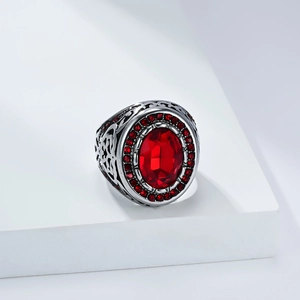 Detailed macro view of retro oval red gemstone ring with intricate Celtic knot engraving