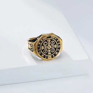 Detail of the golden Saint Benedict medal ring with black enamel religious symbols