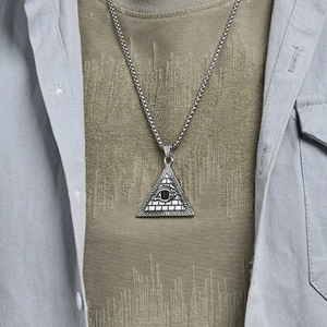 Polished stainless steel pyramid eye pendant necklace worn over streetwear apparel