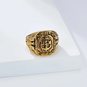 Detail view of gold vintage US Navy USN anchor and eagle seal ring on a white display