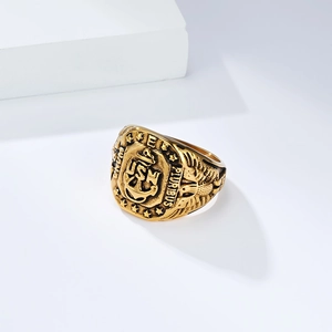 Vintage gold US Navy USN seal ring with anchor and eagle carvings on a white background