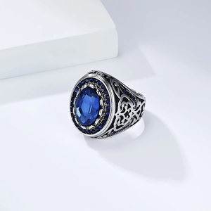 Vintage men's stainless steel ring featuring a large blue gemstone and ornate carvings