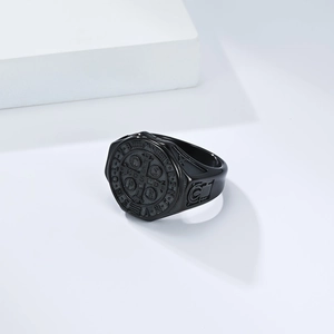 Macro shot of vintage black St. Benedict Medal ring with religious relief details
