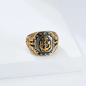 Macro view of USN Navy signet ring featuring golden anchor and eagle wing relief details